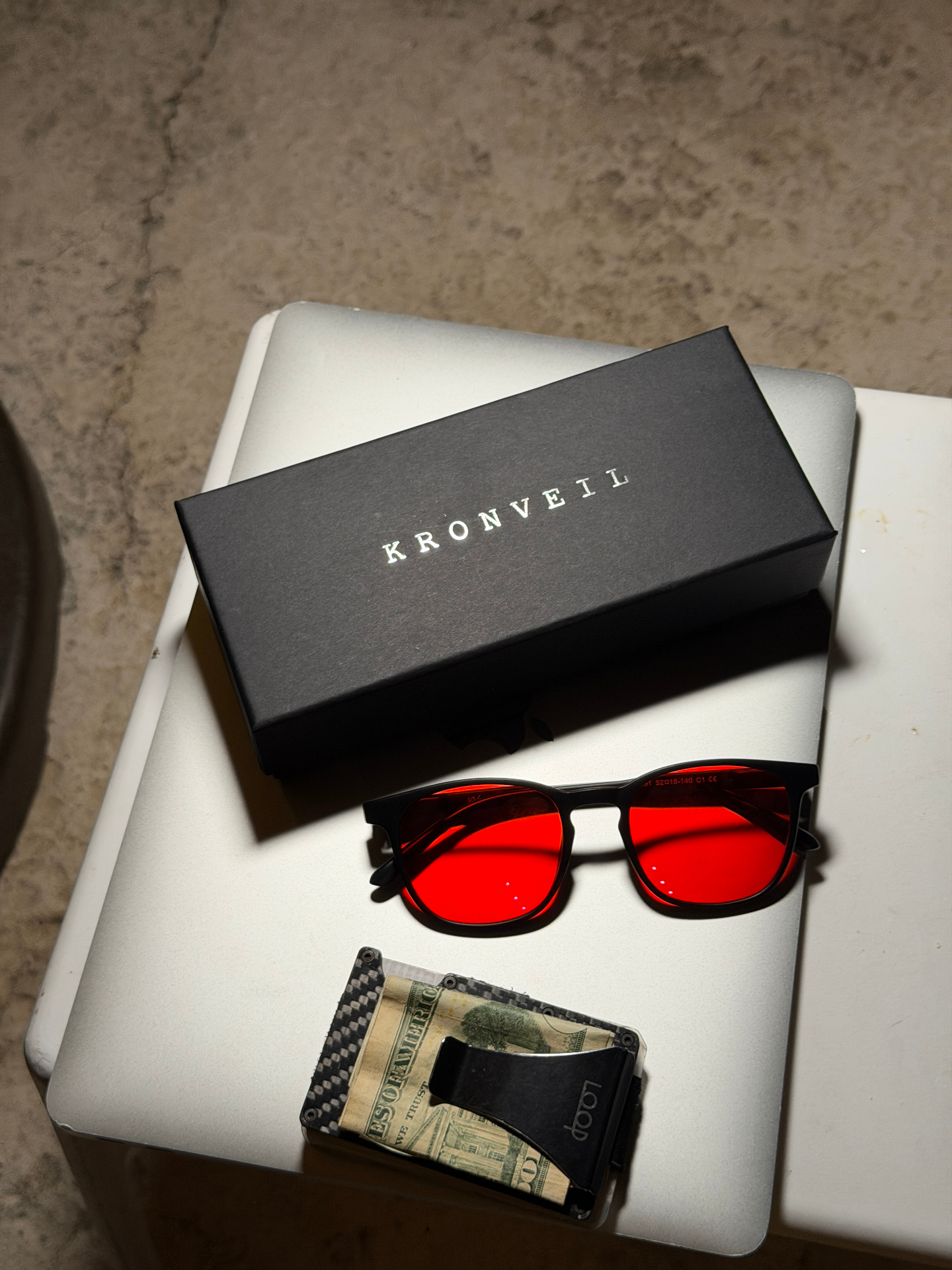 Customer's KRONVEIL gift box and X0-1 glasses on a desk